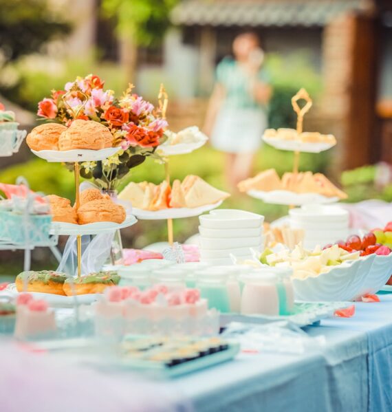 various desserts on a table covered with baby blue cover
